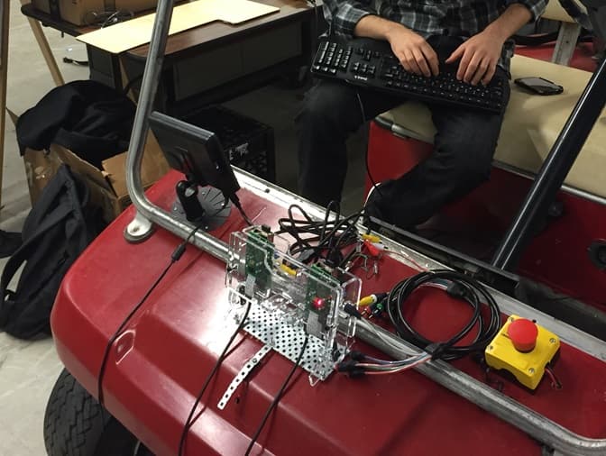 The camera mount attached to the hood of the golf cart.